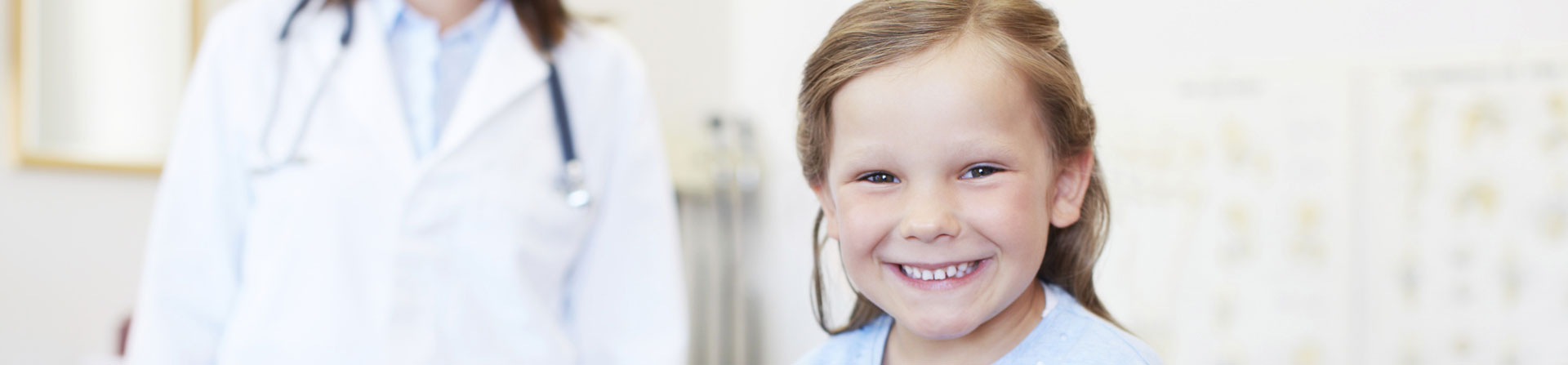 little girl smiling and her doctor