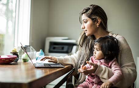 a woman and her child use a computer to access telehealth options