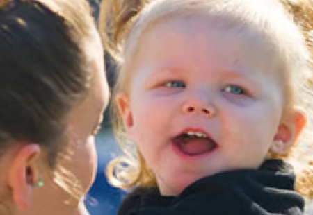 Close-up of smiling toddler post-liver transplant 